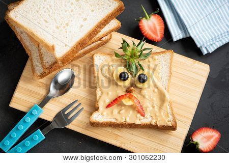 Peanut Butter Toast For Kids. Funny Face Decoration On Breakfat Or Lunch Pb Toast. Meal For Kids. To