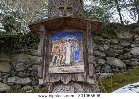 A Primitivism-style Icon (or Picture On A Biblical Theme) On A Tree By A Forest Trail On A Mountains