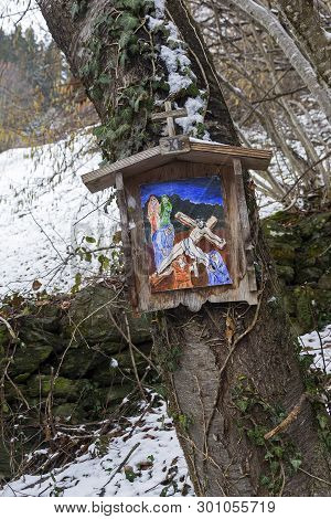 A Primitivism-style Icon (or Picture On A Biblical Theme) On A Tree By A Forest Trail On A Mountains