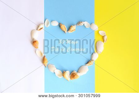 Seashell Heart On The Canary Islands Tricolor Flag Background. Phrase  30 May Canary Islands Day  On