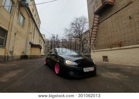 Moscow, Russia - May 08, 2019: A Black Tuned And Understated Volkswagen Golf 6 With Bright Pink Hand