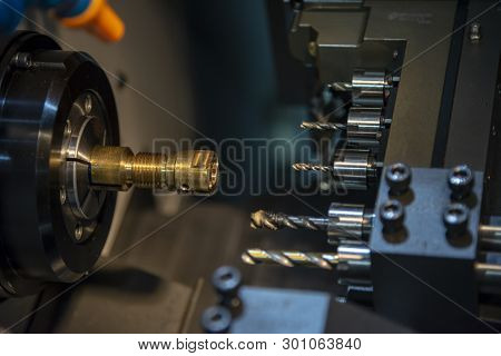 The Cnc Lathe Machine Drilling The Hole On The  Brass Shaft Part With Drill Tool. Hi-technology Auto