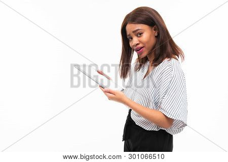 Portrait Of African Young Girl Possing With Grey Tablet In Hands On Background