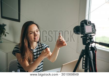 Girl Videoblogger Or Beauty Blogger Records Video For Subscribers. She Shows Lipstick And Tells How 