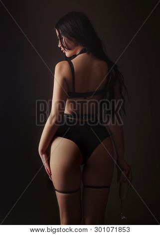 Slim Woman Dressed In Black Lingerie And Tied With Ropes. Female In Sexy Bikini. Lingerie Sexy Girl 