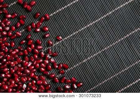 Garnet Seeds Make A Frame In Black Wood Background