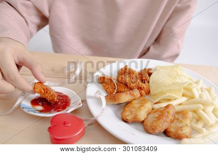 Fried rice with basil leaves and red cloth on the table.Ngredients of Basil Fried Chicken and fried 
