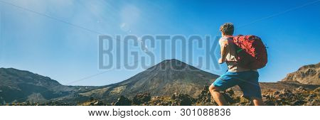 Hiker man hiking in banner landscape Tongariro National Park Alpine crossing hike trail man tramper tramping panoramic. North Island. Adventure travel traveler walking trek with bag backpacking.
