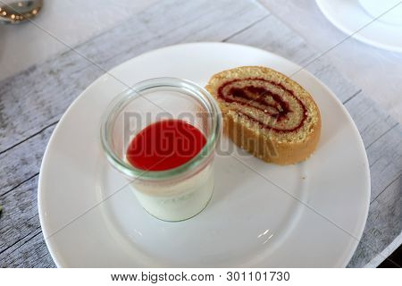 Cake Roll And Panakota On Plate In Restaurant