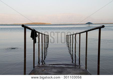 Dead Sea Israel Handrails For Entry. Crystal Sal Beach On Dead Sea Coast, Israel. The Dead Sea Surfa