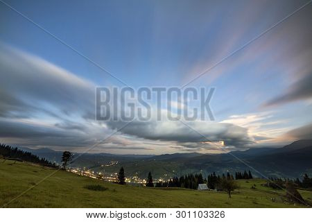 Summer Night Mountain Panorama. Green Grassy Mountain Clearing, Spruce Trees On Blue Evening Sky Cop