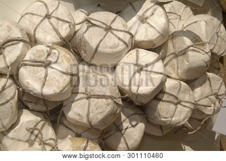 Forms With Freshly Made Cheese On Wooden Table