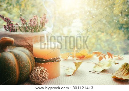 Burning Candle, Hokkaido Pumpkin And Fall Decorations On A Windowboard On A Rainy Day, Space For You