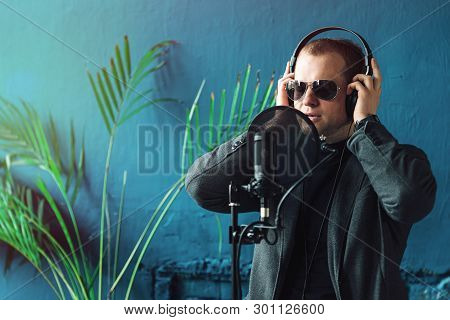 Close Up Of A Man Singer In A Headphones Recording A Song In A Home Studio