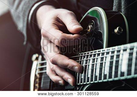 Close Up Shot Of Hands Of Man Playing Electric Guitar