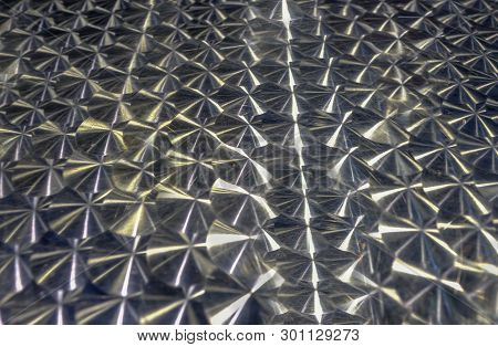 Abstract Shot Of Metal Aluminium Table Top With Lights Shining Down Adding To The Patterns.  Graphic