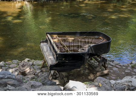 Vilnius, Lithuania - August 2018: Abandoned Gran Piano, Rundown Piano By A River Bank (vilnia River)