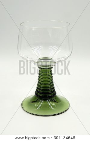 Vintage German Luminarc Mosel Or Rhein Wine Glass With Green Stem Against A White Background.