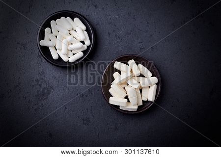 Glutamine And Bcaa Amino Acids. Nutrition For Bodybuilding. Fitness Supplements On Black Stone Backg