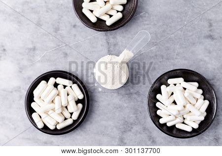 Scoop Of Whey Protein, Hydrolyzed Collagen Type I, L-proline And L-lysine Capsules. Supplements To S