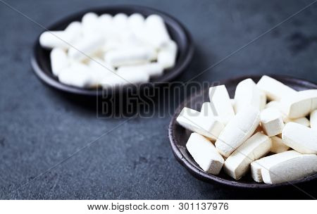 Glutamine And Bcaa Amino Acids. Nutrition For Bodybuilding. Fitness Supplements On Dark Stone Backgr