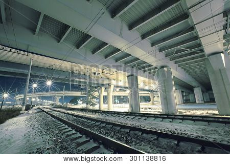 Highway/expressway With Concrete Pillars  In St. Petersburg Over The Railroad At Night, Bottom View.