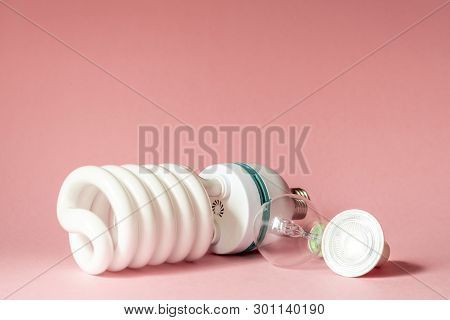 Close Up View Of White Light Bulb Isolated On Pink.