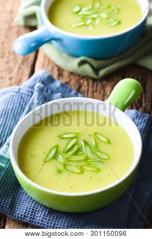Cream Of Green Asparagus Soup In Two Bowls, Garnished With Sliced Asparagus On Top (selective Focus,