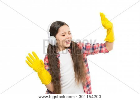 Playing Music Can Cut Cleaning Time In Half. Girl Wear Headphones And Protective Gloves For Cleaning