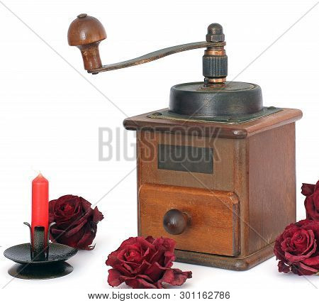 Manual Coffee Grinder With Roses On A White Background. Antiquary