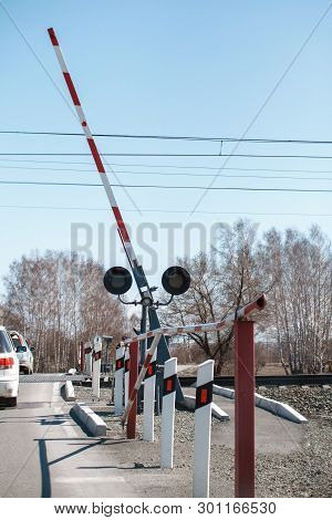 Open Barrier Railway Crossing On The Background Of The Forest. Spring Sunny Day