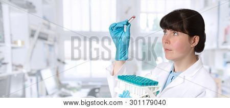 Female Young Doctor-intern, Tech Or A Scientist With Blood Test Tubes Medical Or Research Facility, 