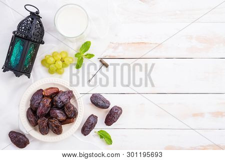 Ramadan Food And Drinks Concept. Ramadan Lantern With Milk, Dates Fruit, Grape And Mint Leaves On A 