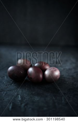 Dark Purple Eggs On A Rough Cement Background.