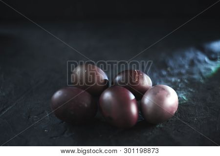 Dark Purple Eggs On A Rough Cement Background.