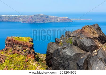 Santorini, Greece Panorama With Skaros Rock, Big Volcanic Stone And Caldera, Sea, Flowers And Volcan