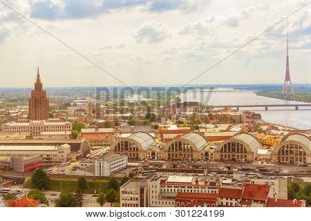 Riga, Latvia 05/17/2018 : Aerial View Of The River Daugava, City Market, Tv-tower And Residential Di