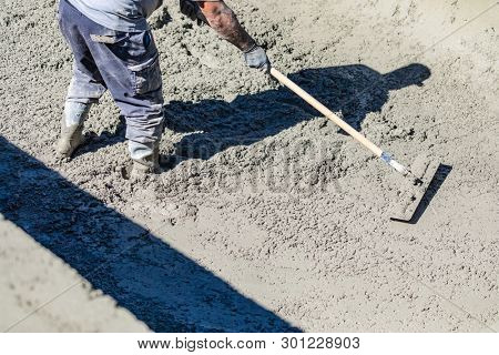Pool Construction Worker Working With A Bullfloat On Wet Concrete