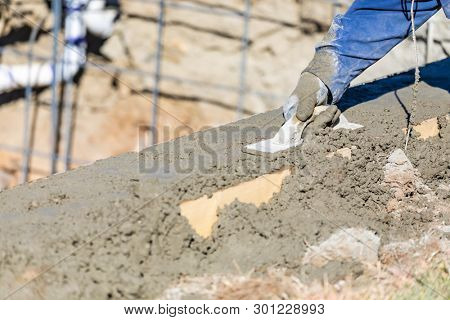 Pool Construction Worker Working With Wood Float On Wet Concrete