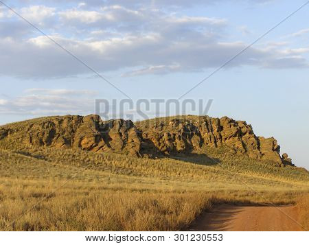 Beautiful View Of The Red Mountain. Natural Elevation In The Steppe.