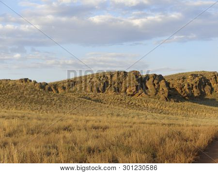 Beautiful View Of The Red Mountain. Natural Elevation In The Steppe.