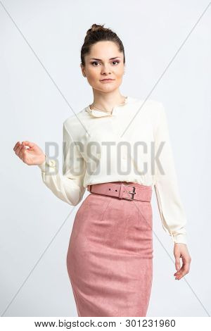 Model In Shirt Of Milk Color, Pink Suede Skirt With Belt, Isolated On White Background.