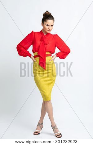 Model In Red Shirt, Yellow Suede Skirt With Red Belt, Isolated On White Background.