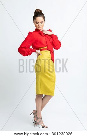 Model In Red Shirt, Yellow Suede Skirt With Red Belt, Isolated On White Background.