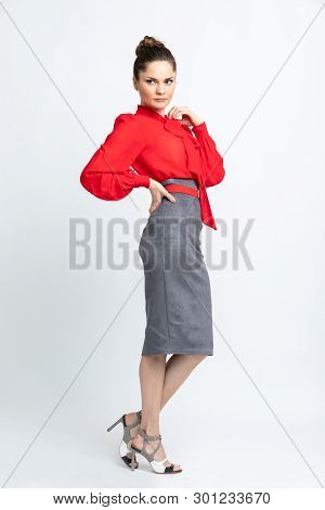 Model In Red Shirt, Grey Suede Skirt, Red Belt, White Heeled Sandals Isolated On White Background.