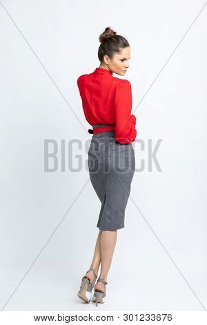 Model In Red Shirt, Grey Suede Skirt With Red Belt, White Heeled Sandals Isolated On White Backgroun