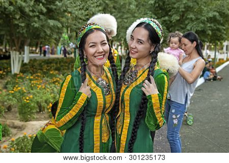 September, 3, 2017. Ashgabat, Turkmenistan : Two Smiling Young Girls In Green National Dresses Befor