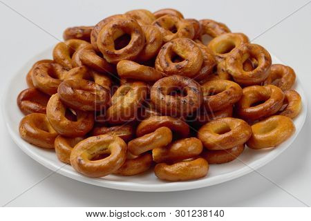 Slides Appetizing Crispy Bagels On A White Plate On A Light Background, Bright Colors, High Contrast