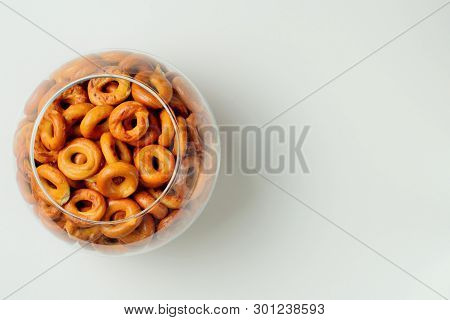 Drying Or Bagels In A Glass Round Vase On A White Background, Plenty Of Space For Text, Bright Color