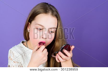 Lets Get Colorful. Little Girl Looking In Glass And Applying Lip Color. Small Child Painting Lips Wi
